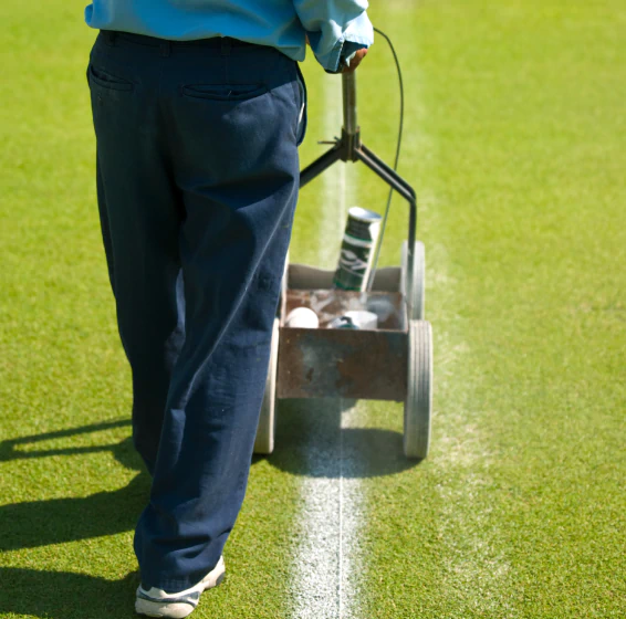 close up worker doing court striping